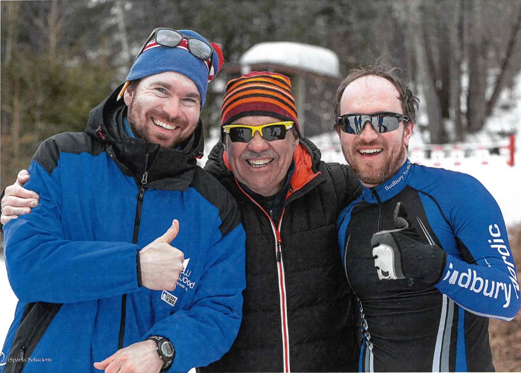 2020 Inductee Peter Wiltmann at a cross country ski race with two unknown people.